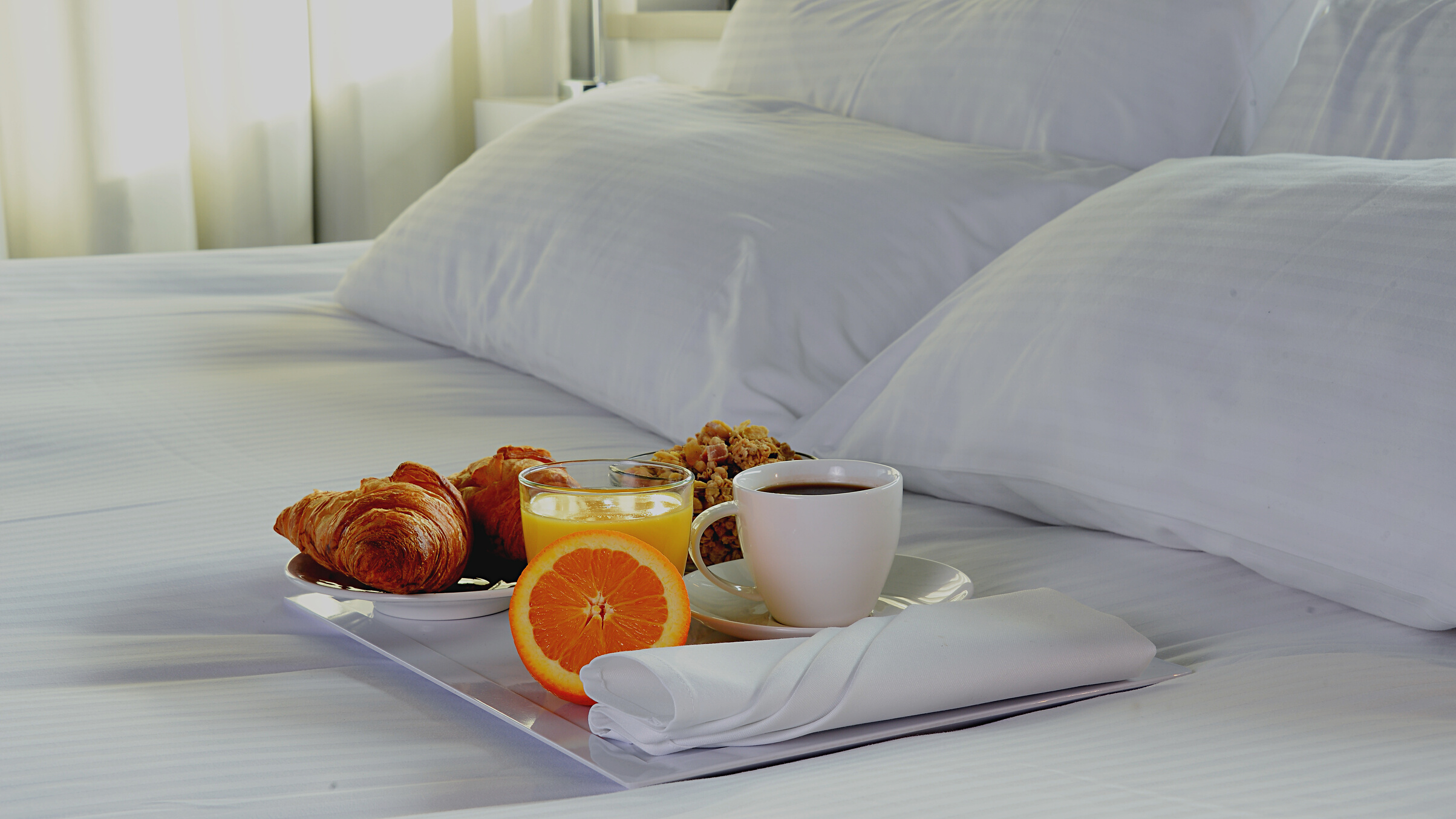 Breakfast in bed in hotel room.